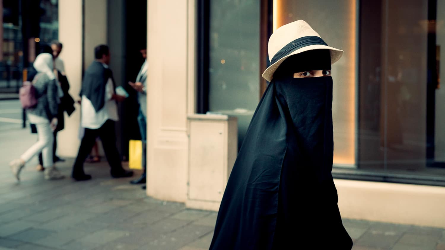 Muslim girl in head covering and hat