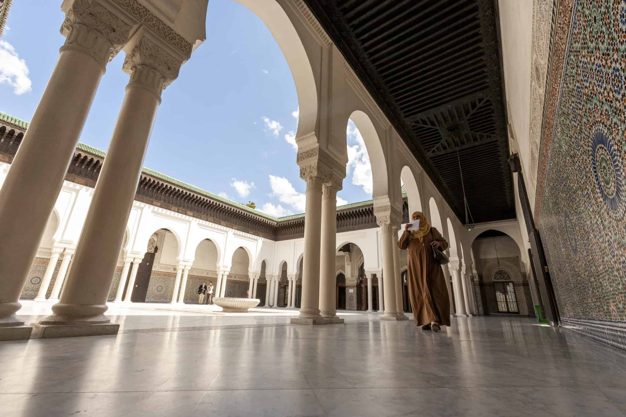 A woman walks through the Grand Mosque in Paris, the largest mosque in Paris.