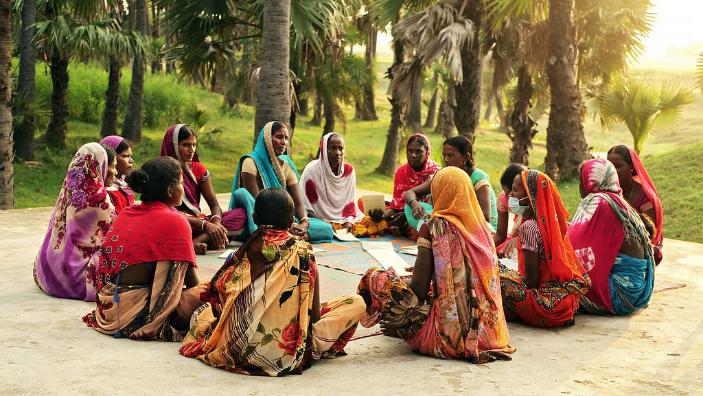 Women from a village in Gaya (a district in the state of Bihar, India), are seen sitting in a circle, attending a community meeting.